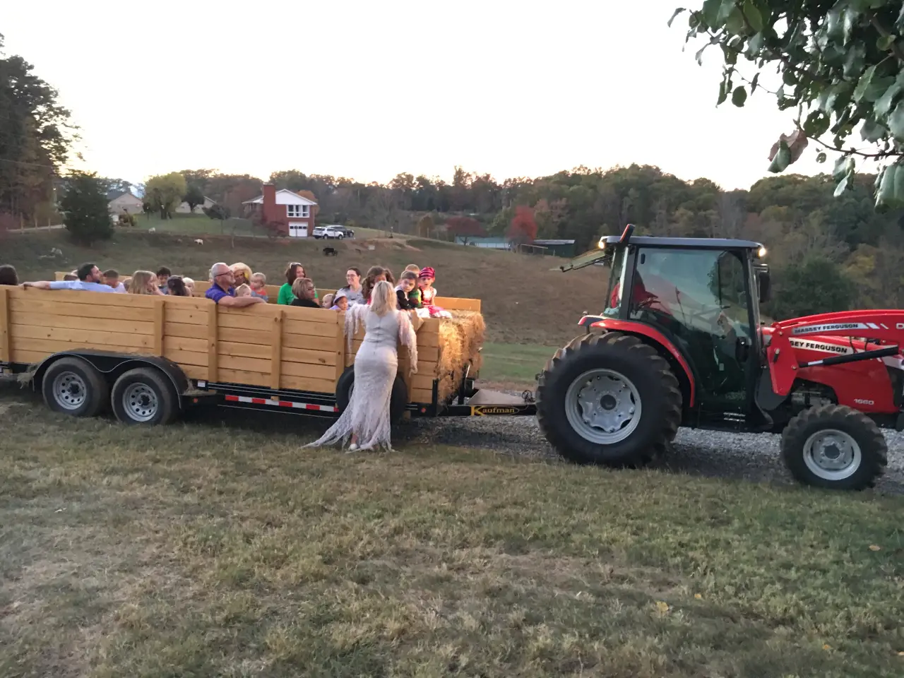 A tractor pulling a trailer full of people.