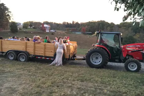 A group of people riding in the back of a tractor.