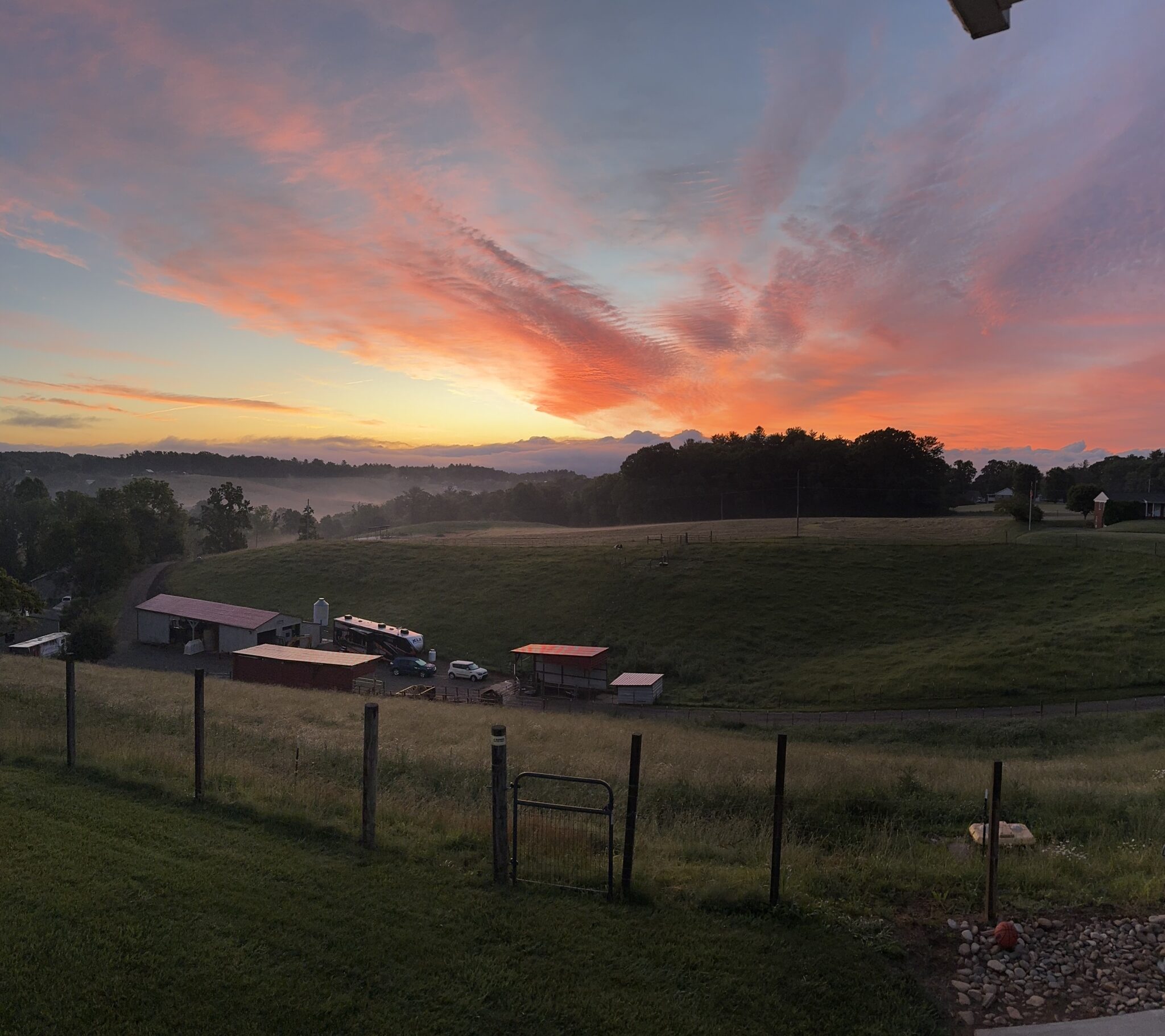 A view of the sunset from an outside farm.