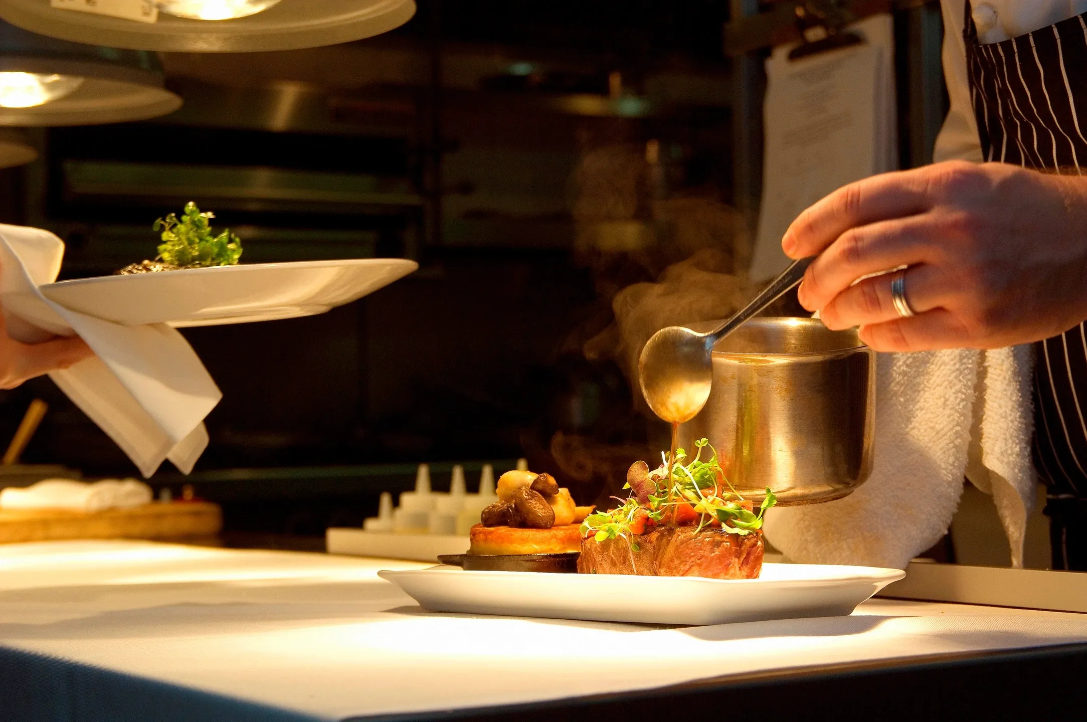 A person is putting food on a plate