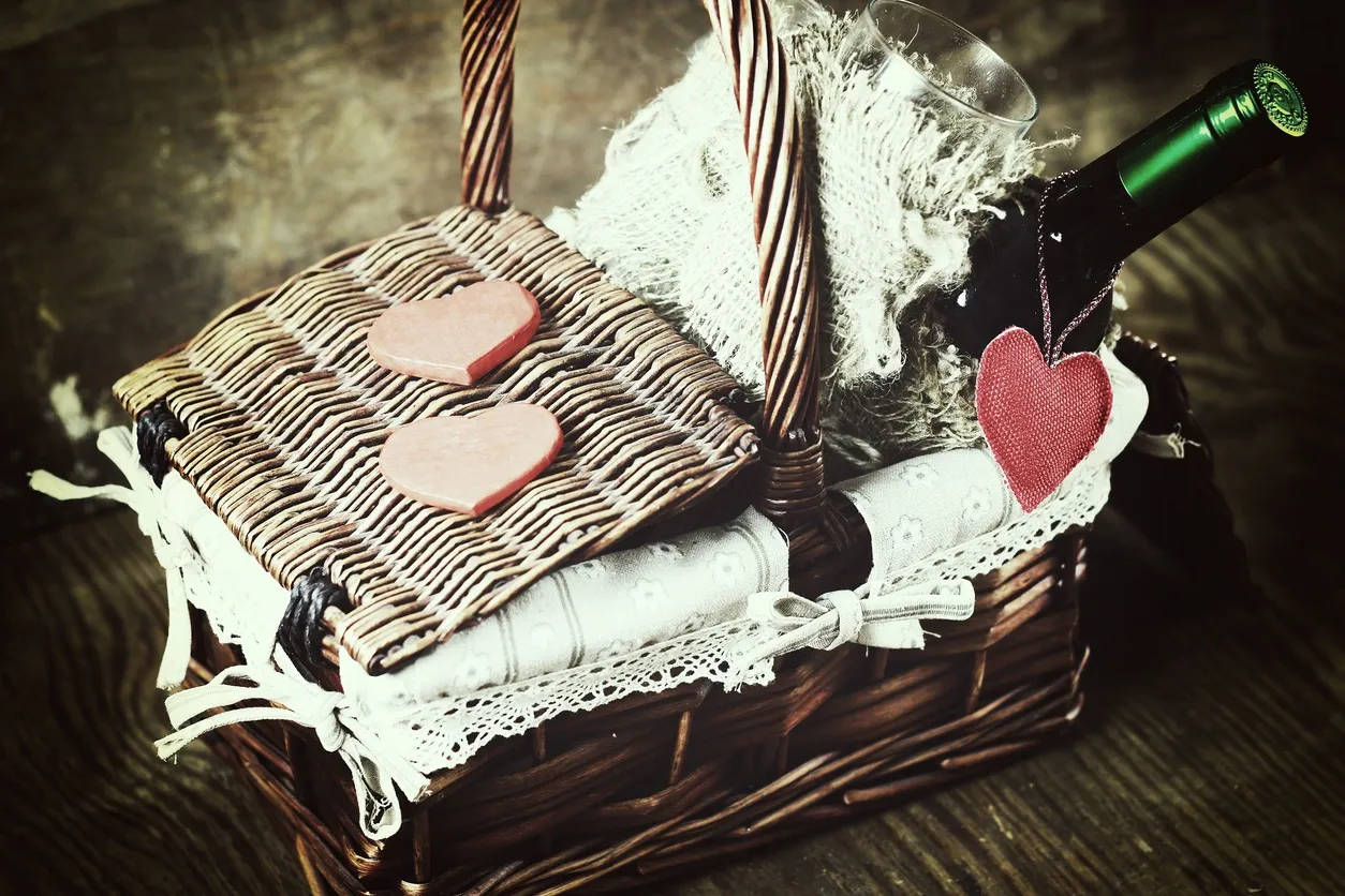 A basket with two hearts on it and some lace.