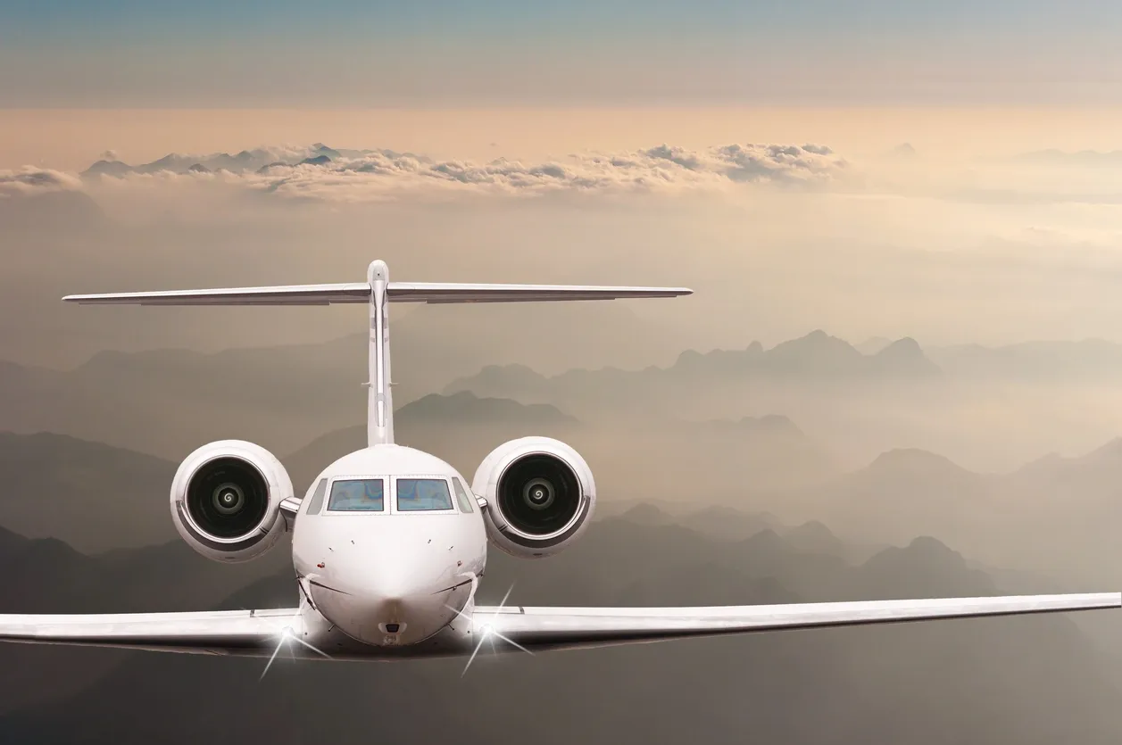 A white airplane is flying in the sky